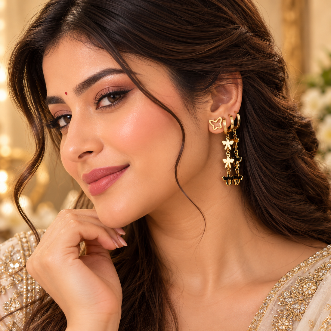 Golden butterfly drop earrings styled on a woman
